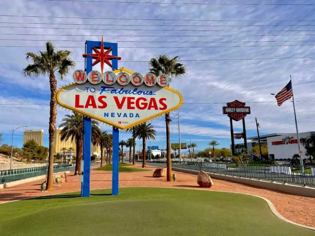 Famous "Welcome to Fabulous Las Vegas" sign with palm trees and blue sky
