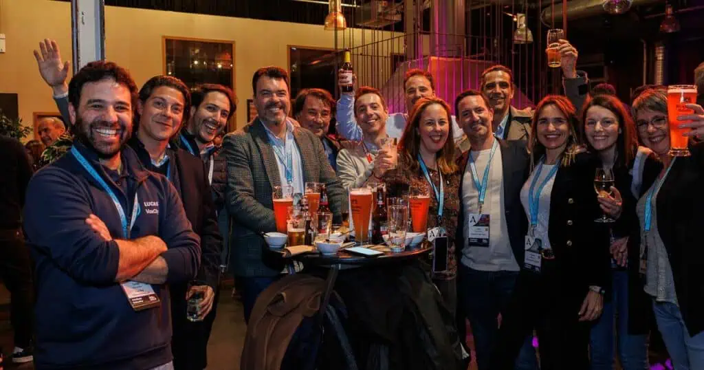 Arival attendees take a break from networking to cheers the camera at an official party on the penultimate evening of the event.